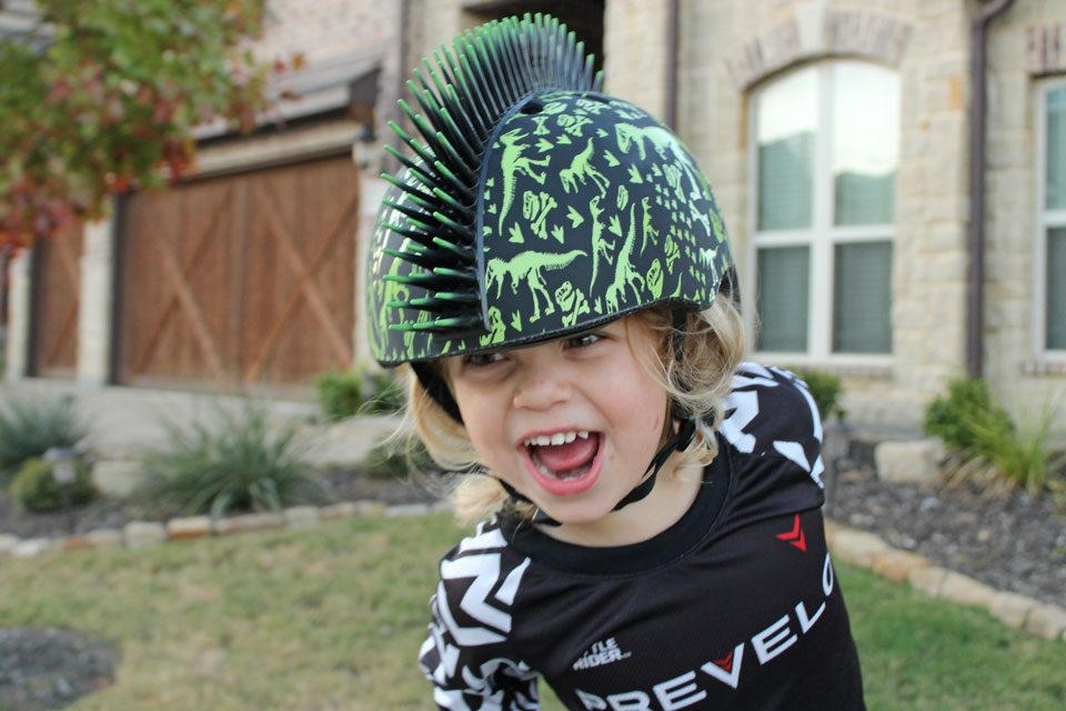 Girl wearing Raskullz kids bike helmet with Mohawk design