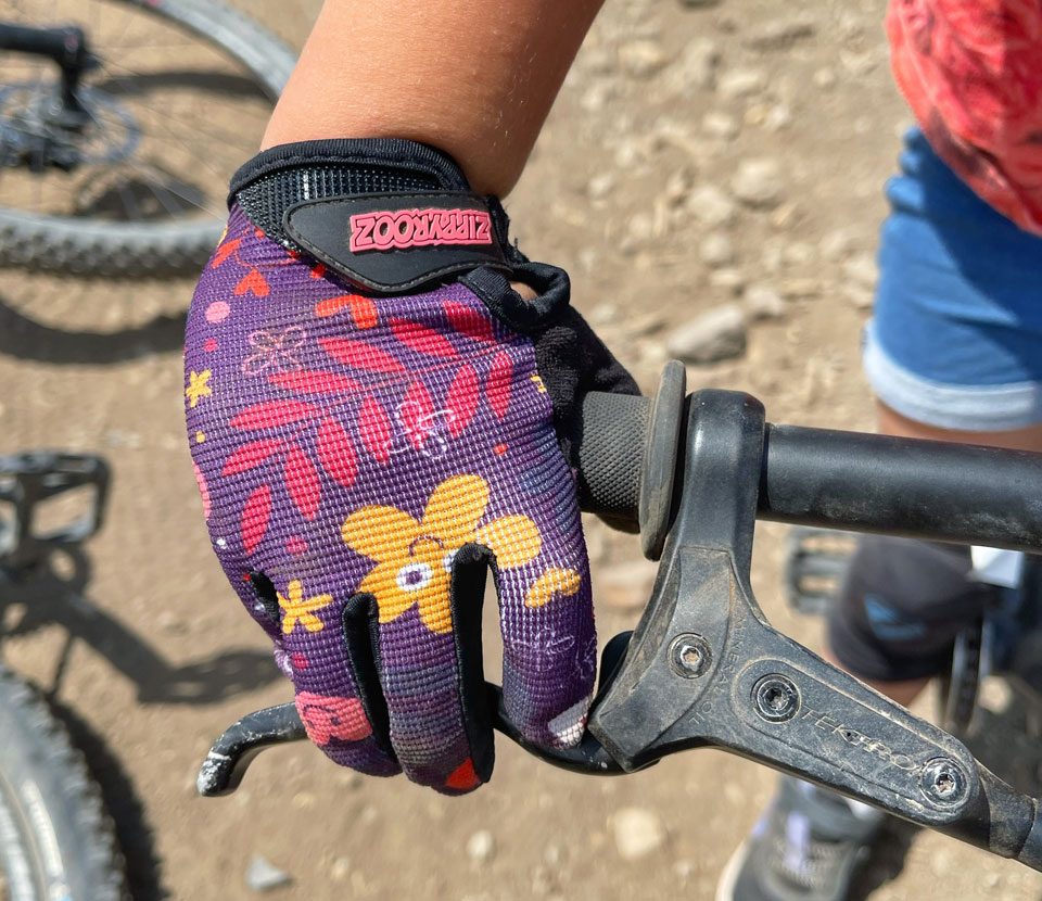 upclose shot of a zippyrooz glove on a 3 year old rider