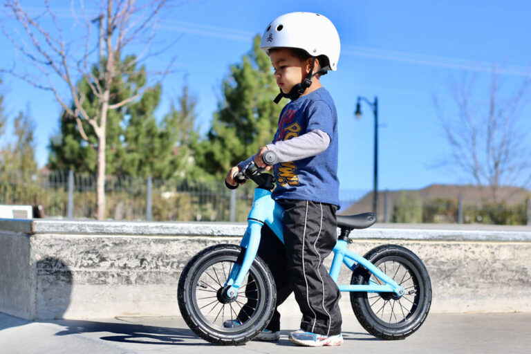 young boy wearing a triple 8 helmet