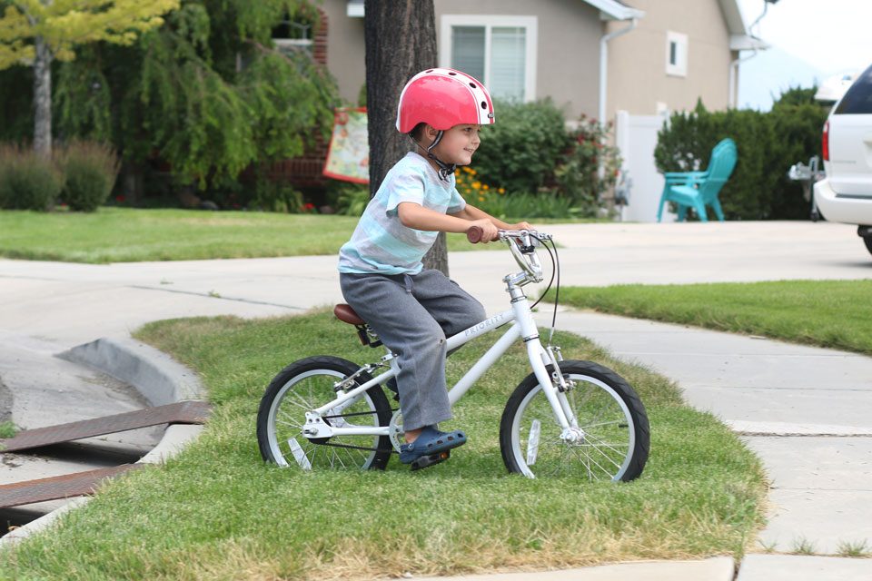 5 year old riding Priority Start 16 across the grass