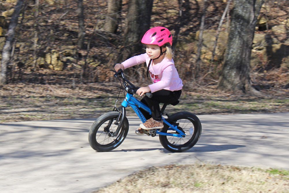 Young girl leaning into turn on the Spawn Yoji.