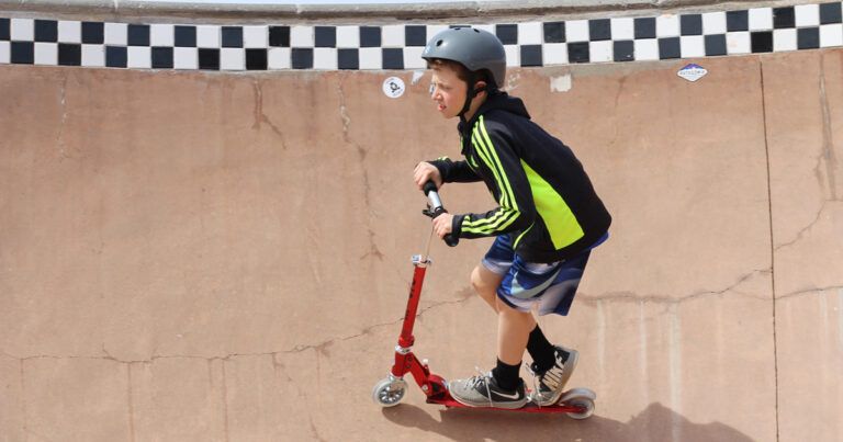 boy riding the micro sprite kick scooter at a skate park