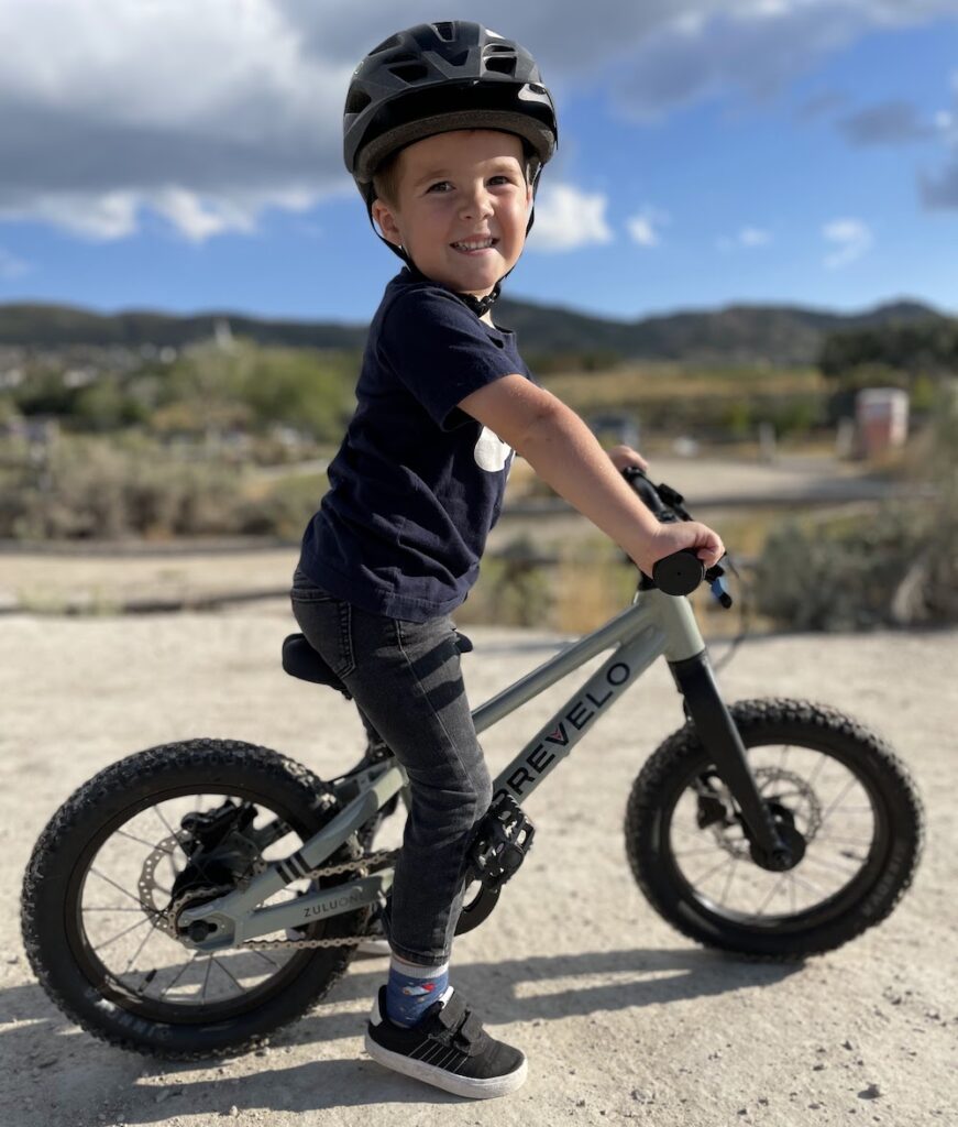 Young boy smiling while sitting on the Prevelo Zulu One.