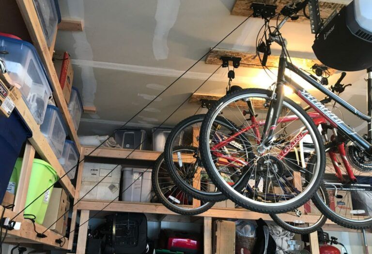 bikes mounted on the ceiling of a garage using the racor bike lift