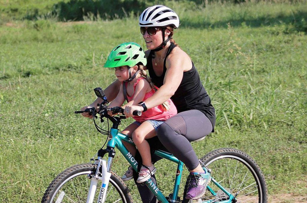 mother riding with her daughter on a do little mountain bike child bike seat