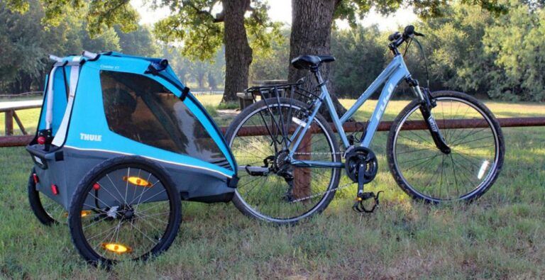 blue thule xt coaster bike trailer attached to a bike
