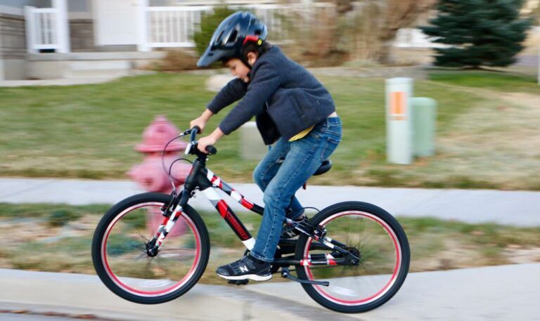 boy jumping off a curb riding a guardian 20 inch bike