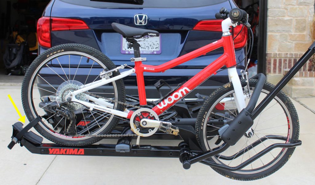 the Yakima HoldUp EVO bike rack mounted onto a Honda Pilot with a woom bike attached