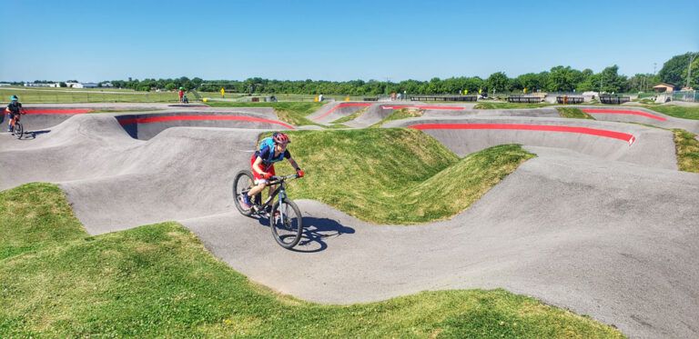 13 year old on 26" woom OFF mountain bike riding on Velosolutions pump track at Runway Bike Park