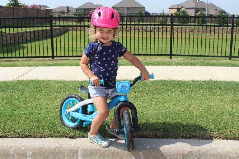 2 year old riding Chillafish BMXie2 balance bike and smiling