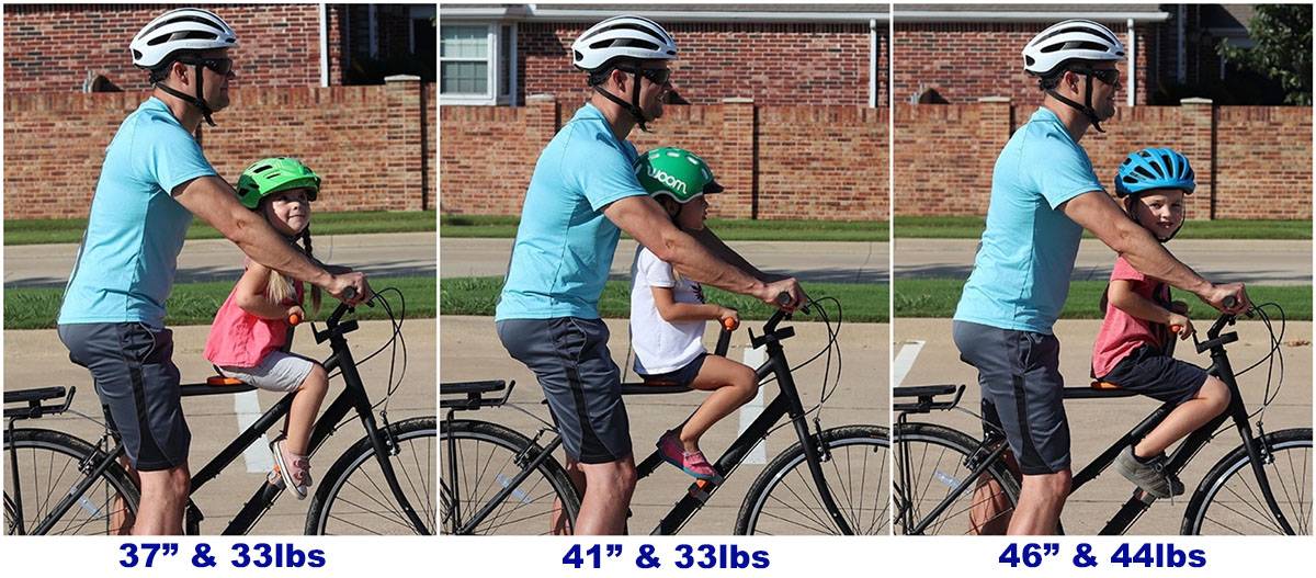 Side by side sizing comparison of 3 kids of different ages on the Tyke Toter with dad