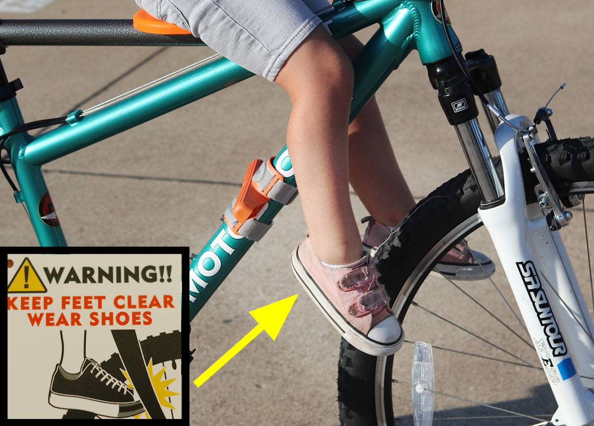 Picture of child's feet dangling close to wheels when not on the footpegs of the Tyke Toter child bike seat