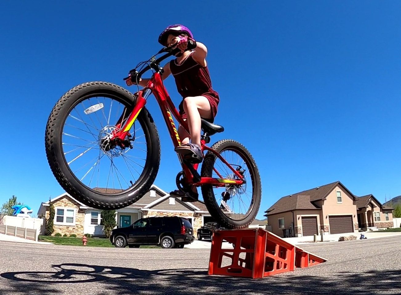 8 year old girl riding a mountain bike off a Byclex kicker ramp. The Yumpy is one of our favorite kids bike ramps.
