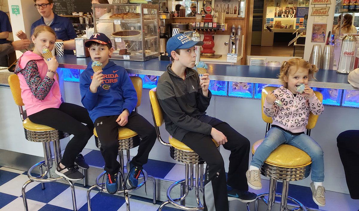 4 kids eating Spark ice cream at Walmart Soda Fountain in downtown Bentonville Arkansas