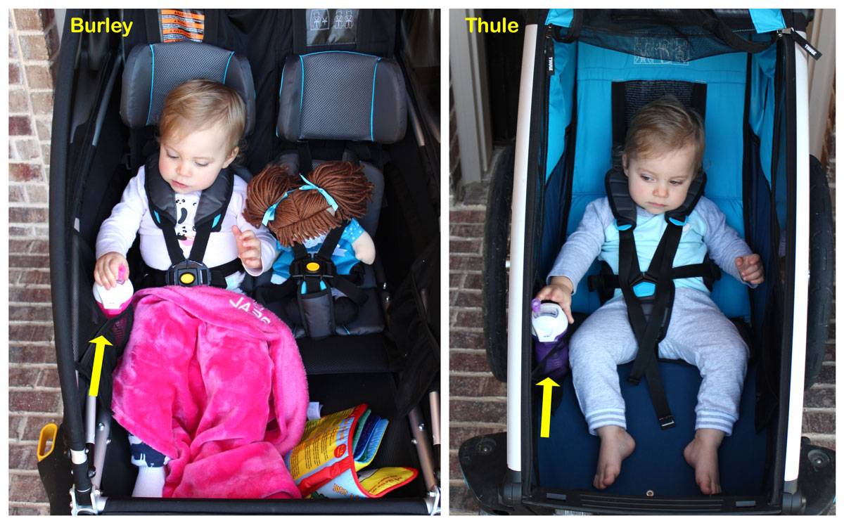 Burley D'Lite X vs Thule cross placement of mesh sippy cup holders. In the Thule, the toddler has to reach farther to grab the cup.