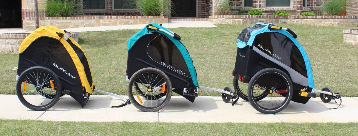 Side shot of the Burley Bee, Burley Encore X, and Burley D'Lite X bike trailers side by side