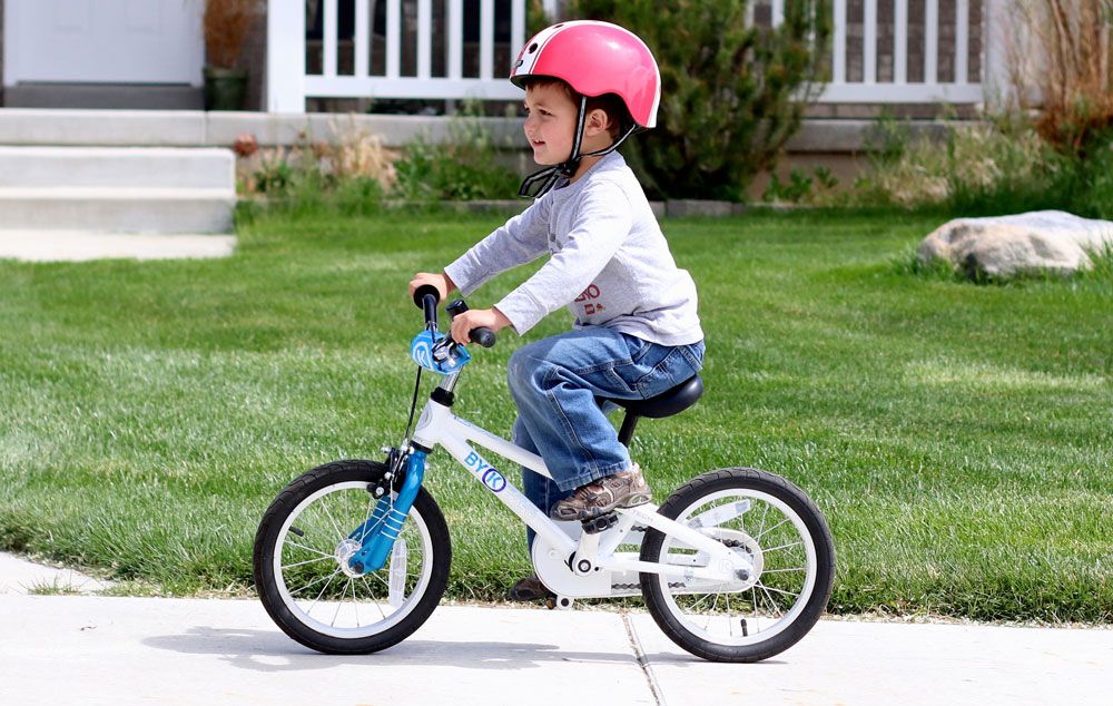 young boy riding a 14 inch byK e250 kids bike
