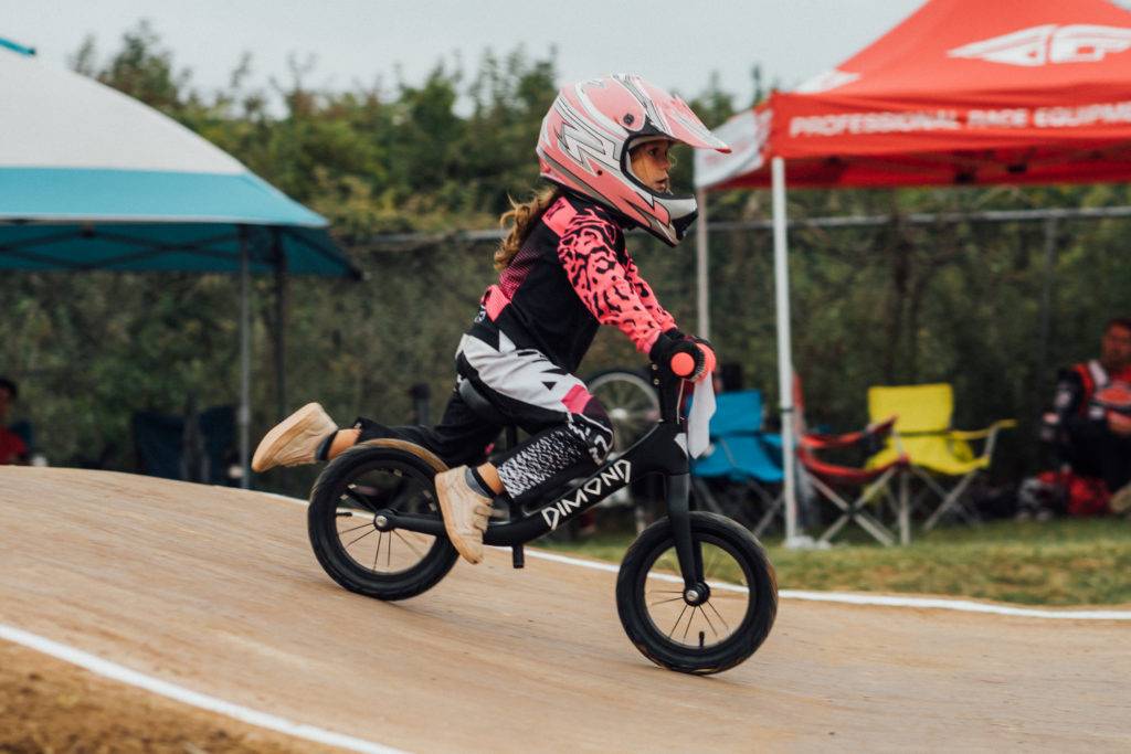 5-year-old girl racing on the Dimond Miner balance bike