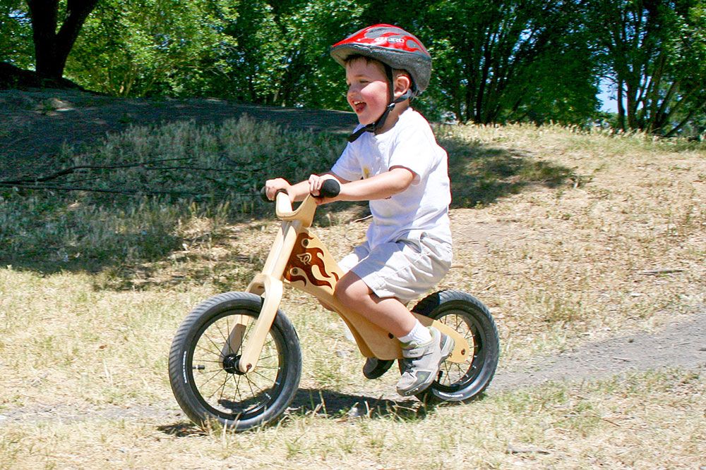 3 year old riding Early Rider wooden balance bike