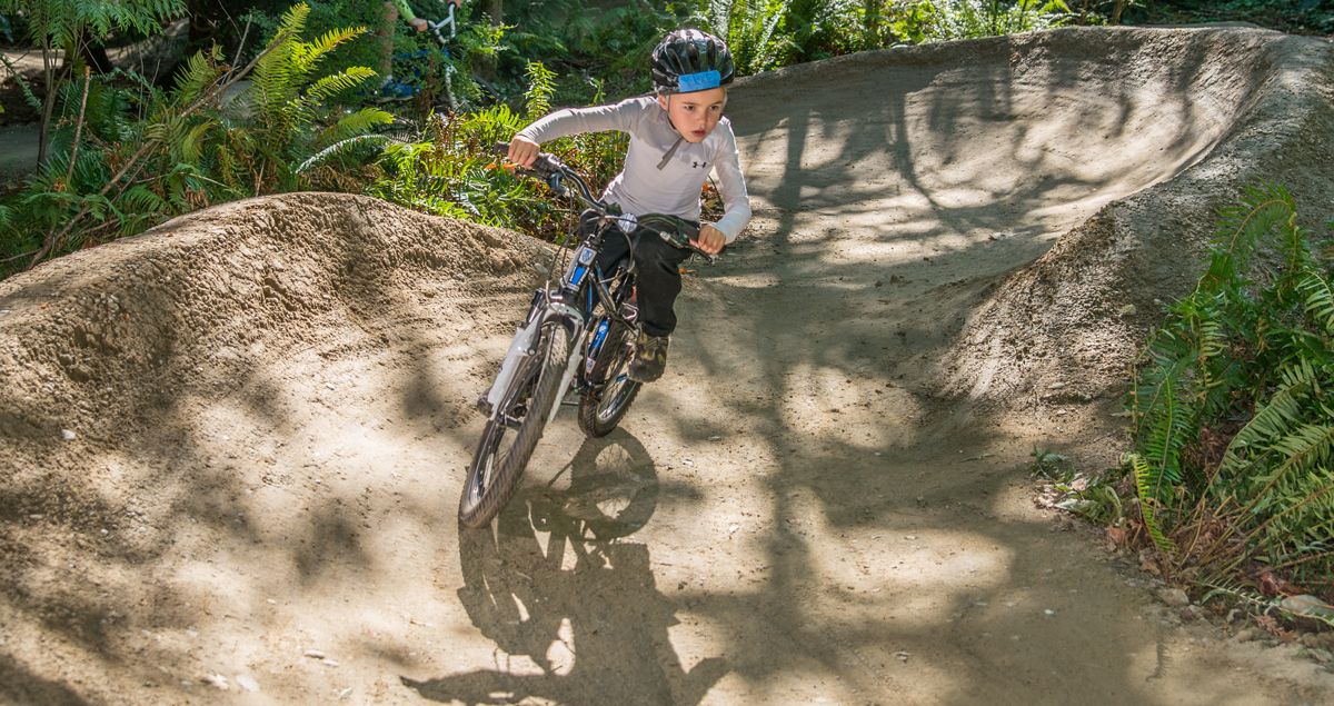 8-year-old boy riding mountain trail at Griffin Bike Park