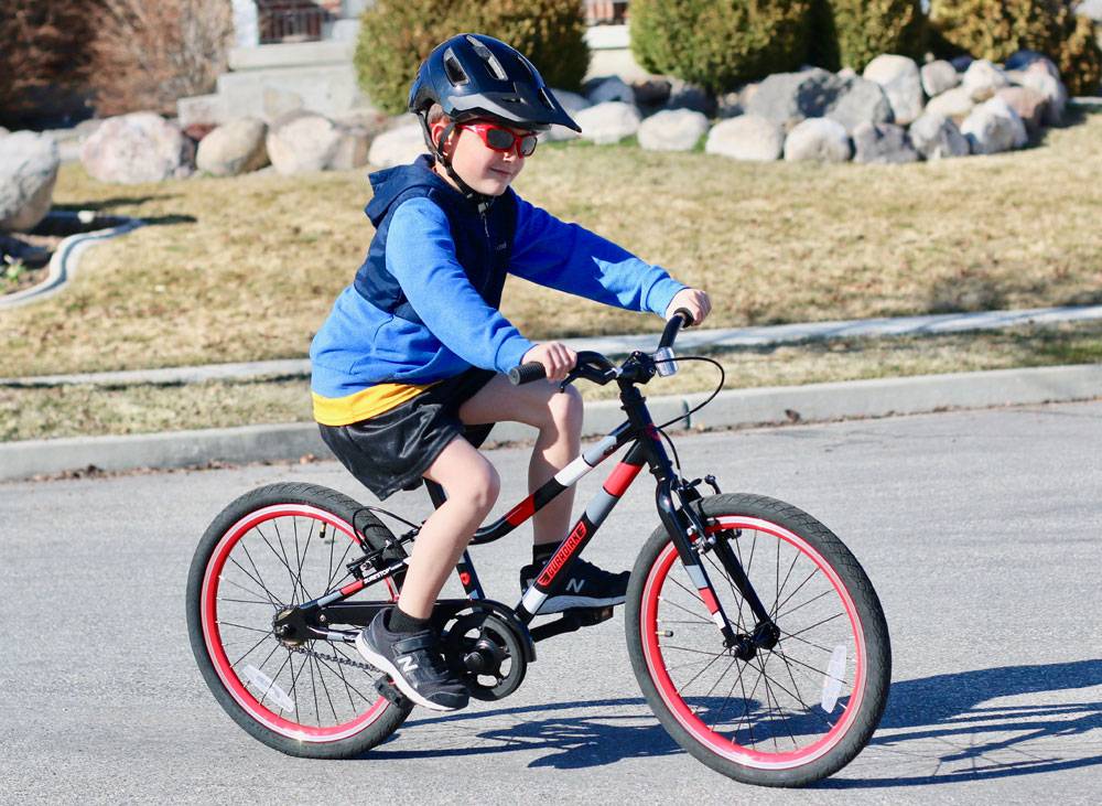 7-year-old riding Guardian Ethos 20" Small bike in black and red