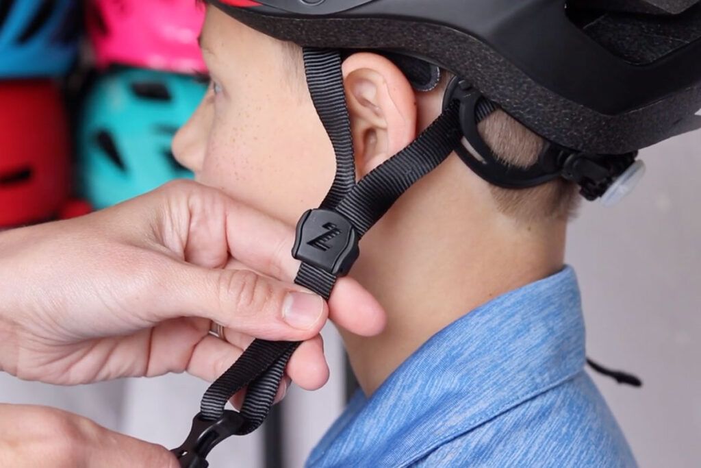 adjusting the sides of a kids helmet to get the right size