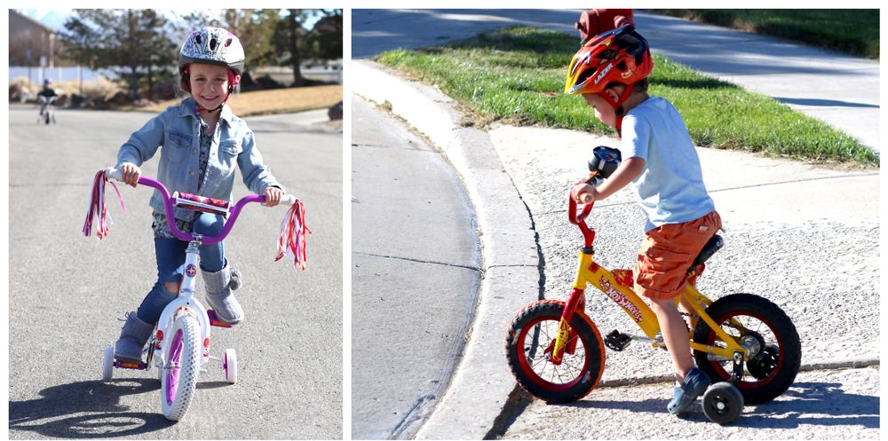 Two young kids riding training wheels at a tilt, showing them off balance