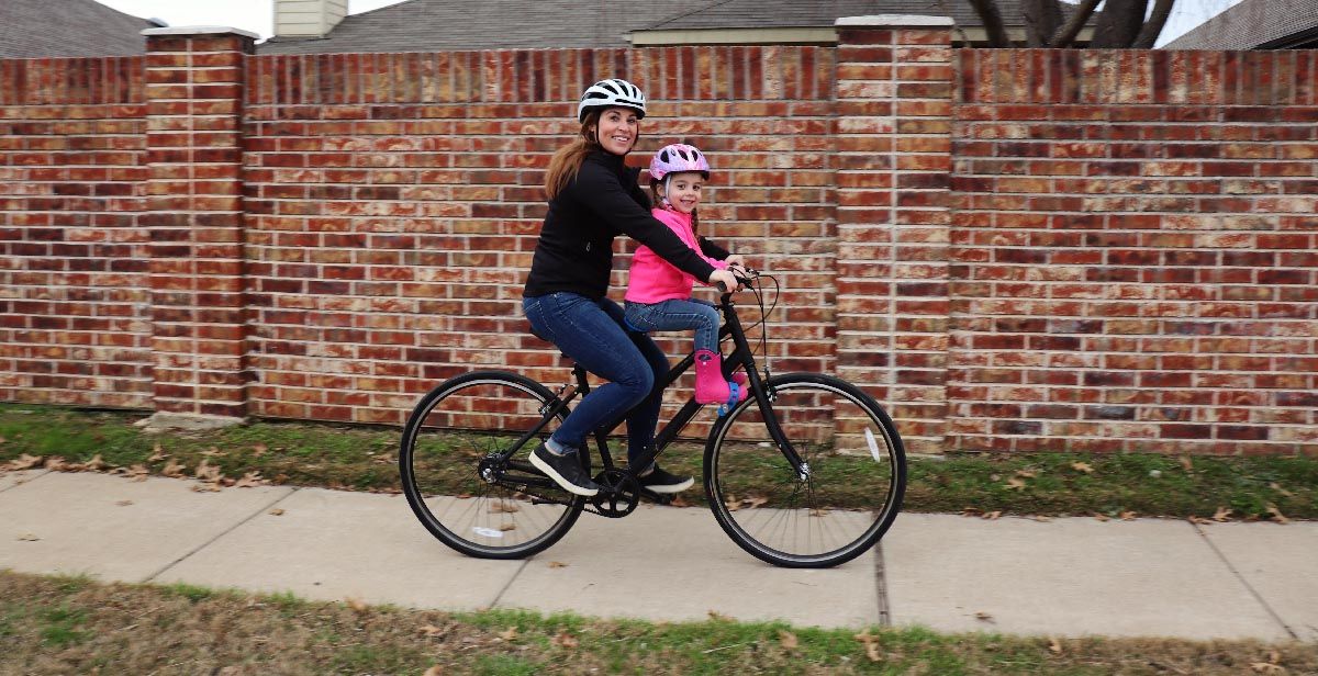 Mom riding with her daughter on the Priority Classic Plus