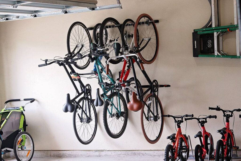 Omni wall mounted bike rack on the garage wall and loaded with five bikes