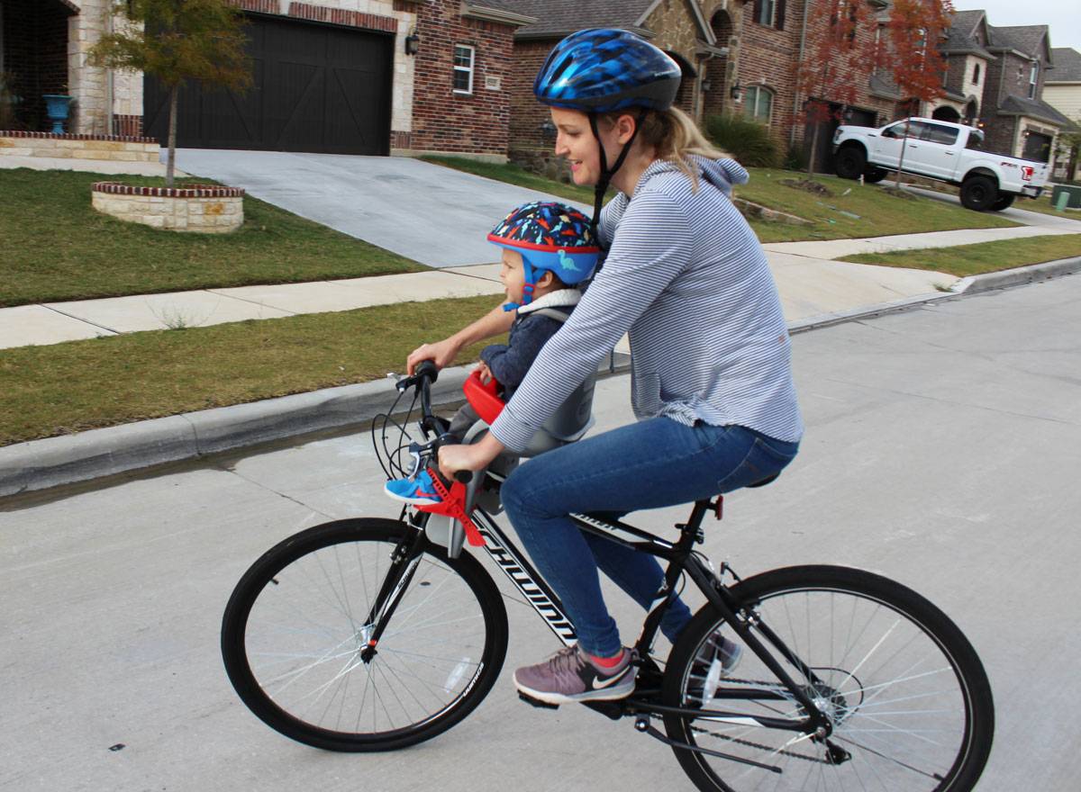 Mom riding with 15-month-old boy in Peg Perego Orion child bike seat