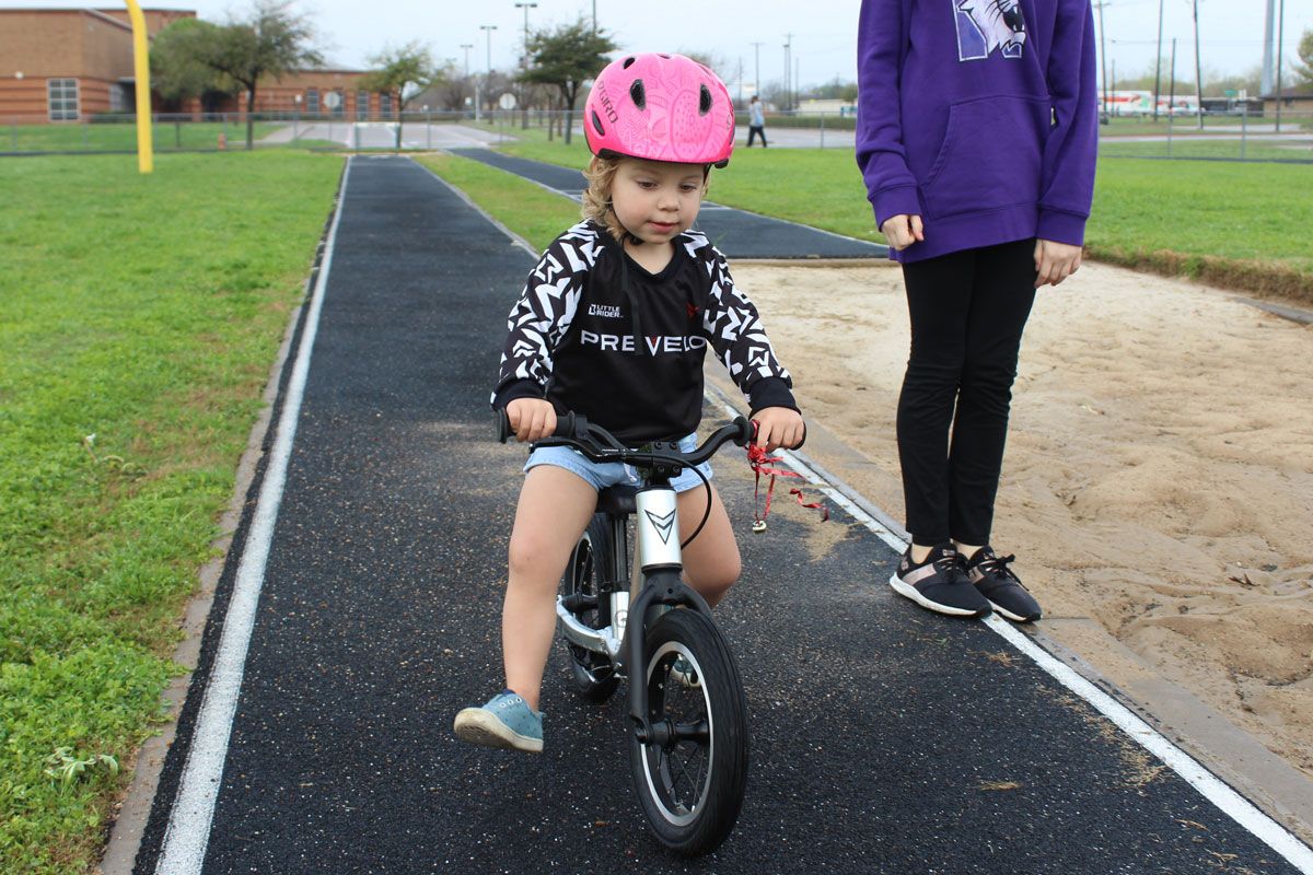Young girl riding the Prevelo Alpha Zero on a track
