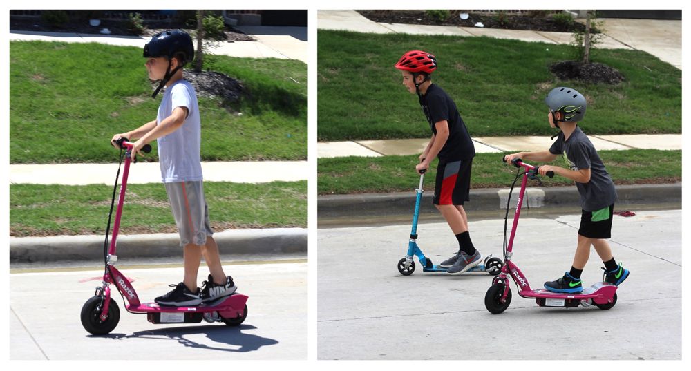 Boy racing his Razor E100 electric scooter against his friend on a traditional kick scooter.