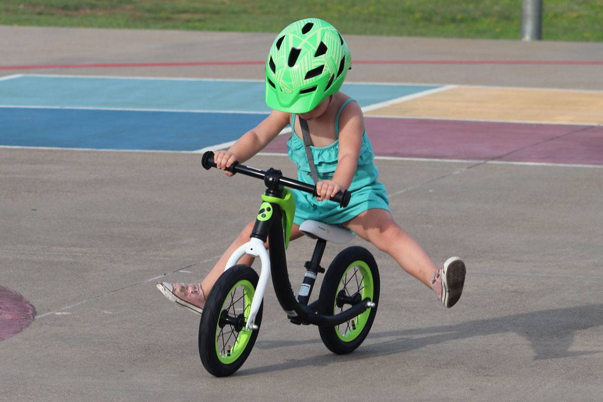 3 year old riding RoyalBaby Pony balance bike with feet up in the air