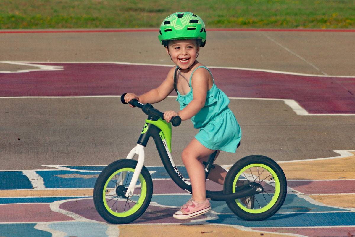 3 year old riding RoyalBaby Pony balance bike with huge smile