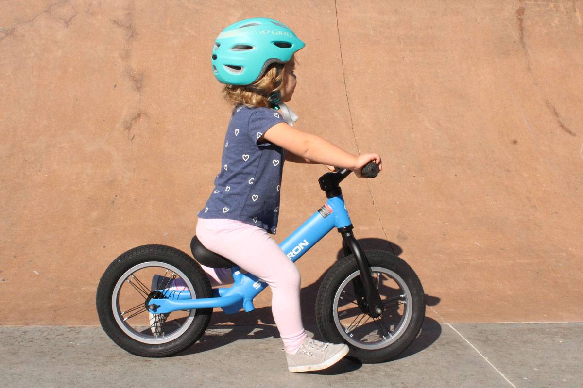 2 year old riding Swagtron K3 balance bike at skatepark