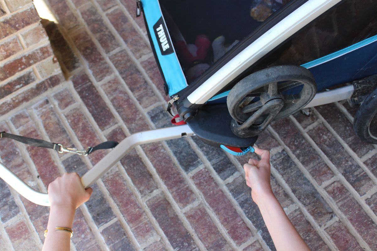 Inserting trailer tow arm into Thule Chariot Cross trailer