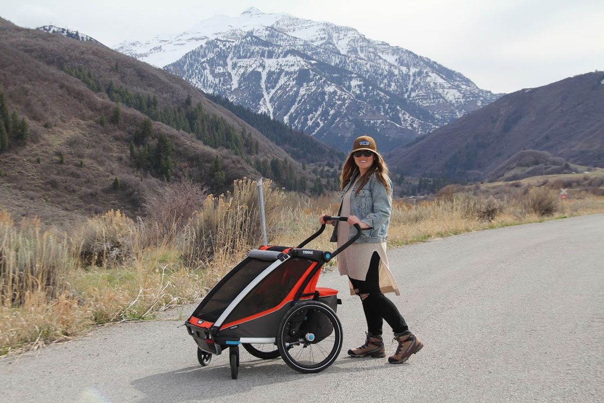 Mom with Thule Chariot Cross 2 double stroller with mountain backdrop