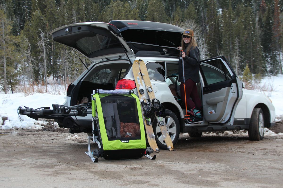 Mom unloading Thule Chariot Cheetah XT with Thule Chariot Ski Kit from her car.