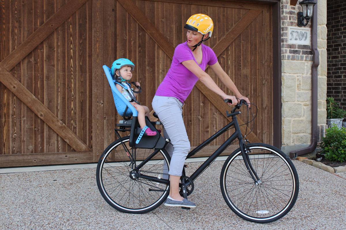 Mom riding with toddler in Thule Yepp Maxi child bike seat