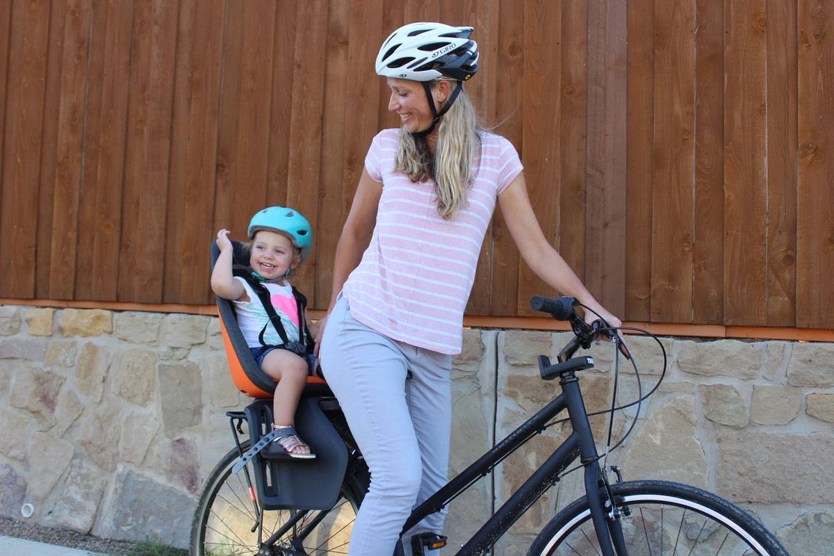 Mom smiling with toddler in Thule Yepp Nexxt Maxi child bike seat