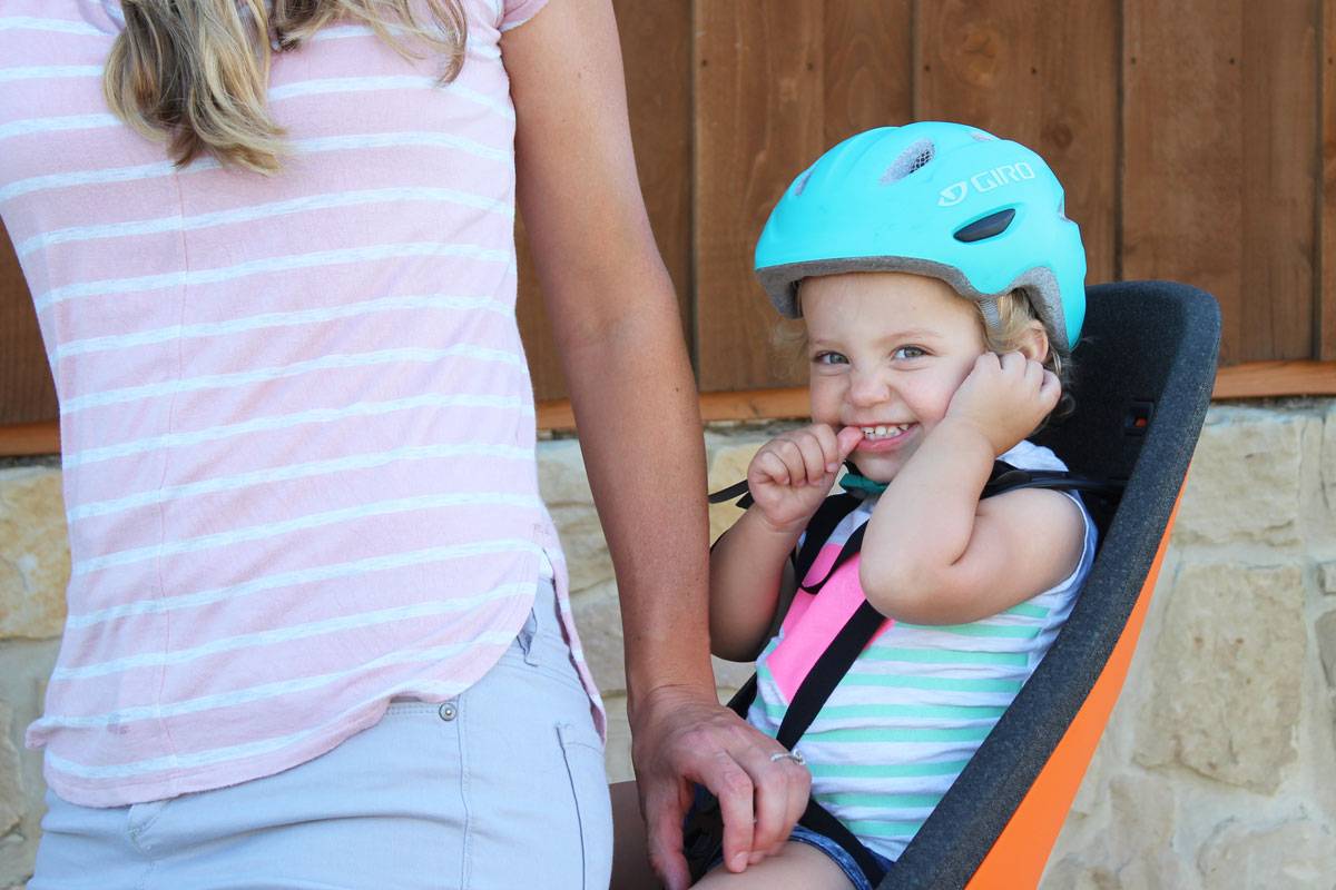 Toddler smiling while sitting in Thule Yepp Nexxt Maxi child bike seat