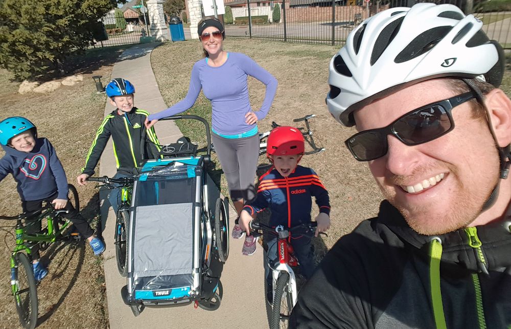 Thule Cross with Thule Infant Sling with infant inside on walk and bike ride with family