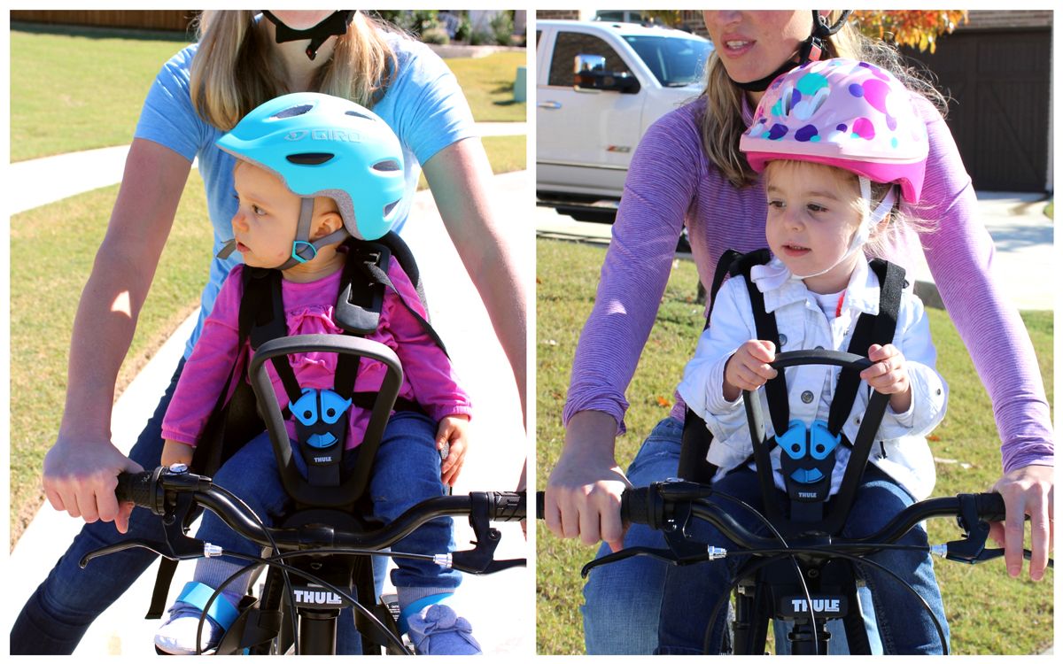 Mom with 12-month-old on Thule Yepp Nexxt Mini and with 2.5-year-old on Thule Yepp Nexxt Mini. The older child's helmet reaches past the woman's chin.