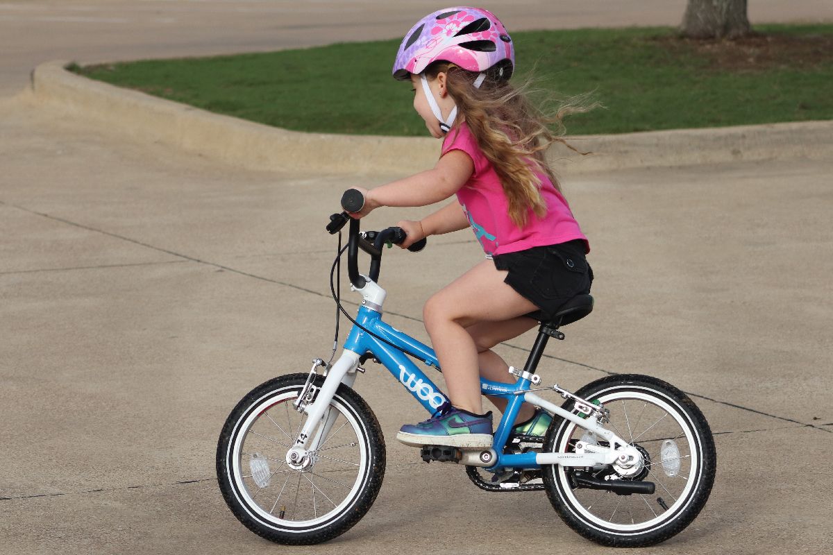 young girl on the woom 2 14 inch kids bike