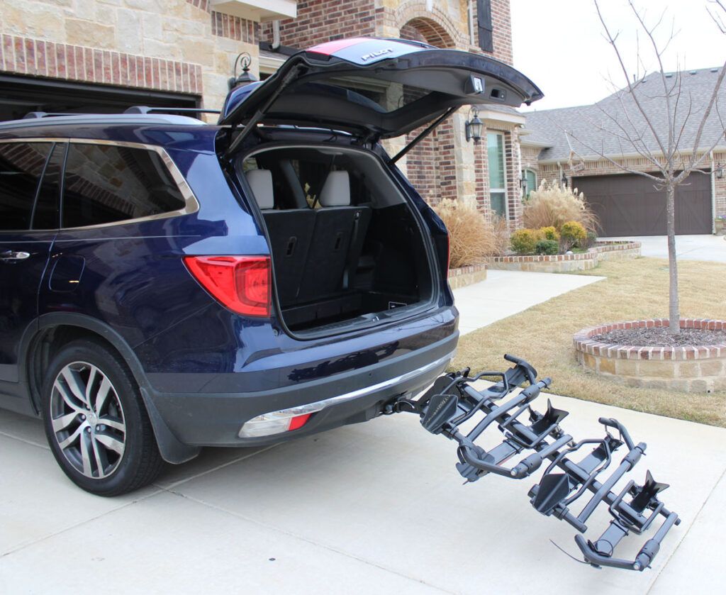 Yakima holdup bike rack tilted down to show rear hatch access on an SUV