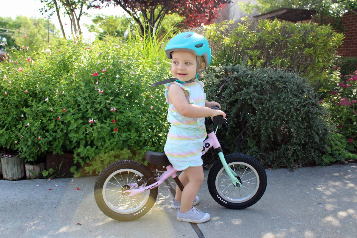 young toddler riding pink Yedoo Too Too balance bike