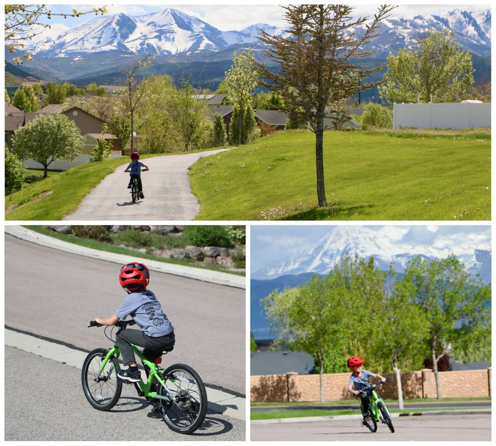7 year old boy riding Cycle Kids 20" bike on paved trail with mountains in the background