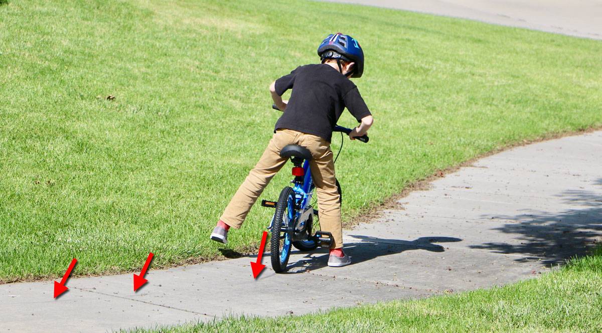 5-year-old boy riding 16" cycle kids bike with skid marks behind him