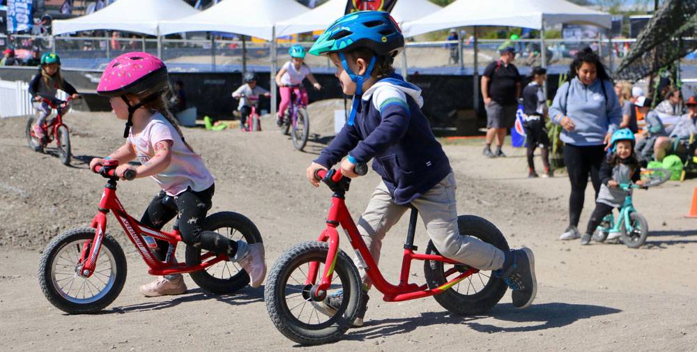 Toddler riding the 2019 Specialized Hotwalk balance bike at the Sea Otter classic.
