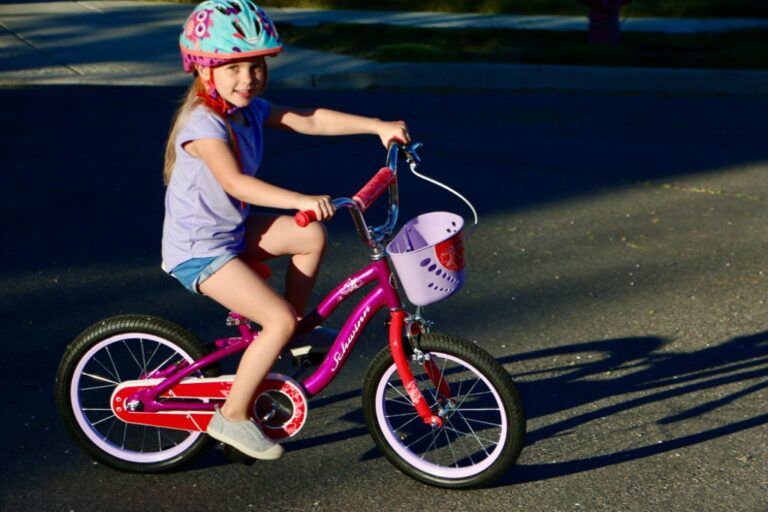 young girl riding a schwinn elm 16 inch bike